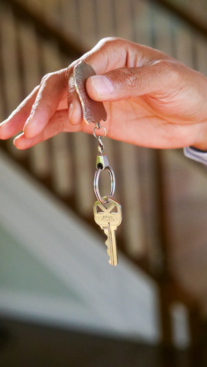 about-us-02 Close-up of a hand holding a key, symbolizing new homeownership or rental.